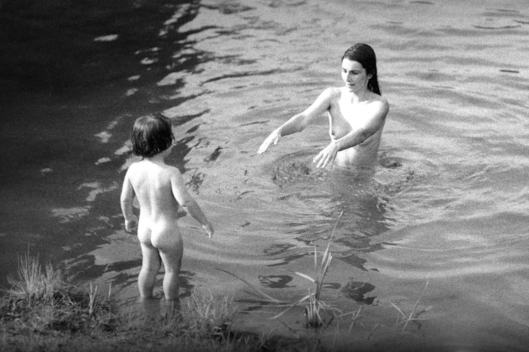 A mother and her child swim in the lake during the Alternative Media Conference at Goddard College in 1970 in Vermont.