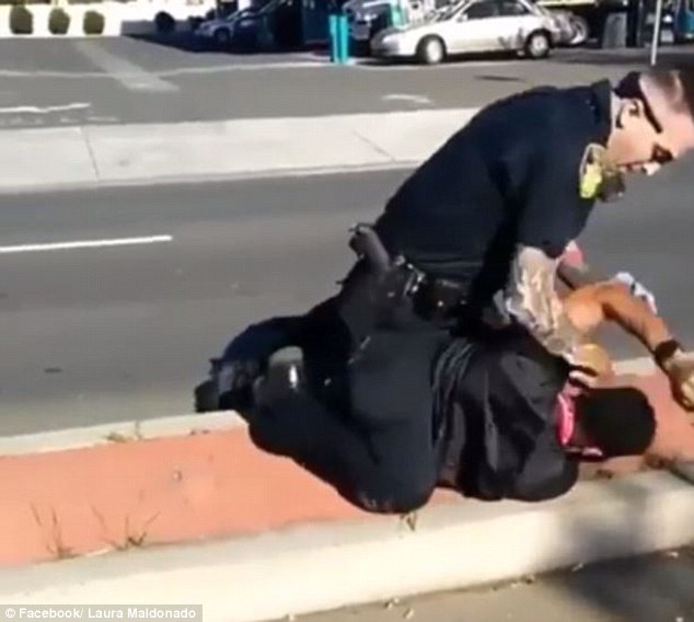 The incident occurred on Friday afternoon in Vallejo at a Vallero gas station when police responded to a 911 call where someone claimed a man was acting 'crazy'. The officer chases the suspect into the street before he tries to arrest him (above)