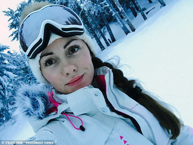 Natalia Boradina (pictured on a skiing holiday), 35, was filmed hanging topless out of a window during a holiday in the Dominican Republic