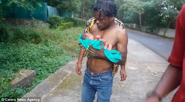 Her hero: Dheeraj Rathore, who runs a tea stall, heard the baby cry  from a bin in some bushes in Bhopal in the central Indian state of Madhya Pradesh