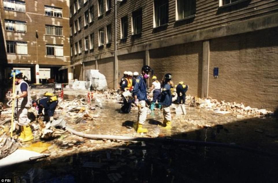 The damaged Pentagon building is pictured above as FBI and other emergency officials work together