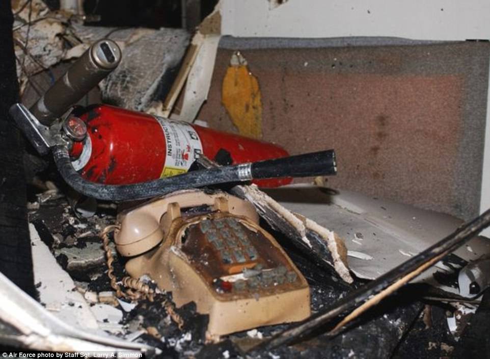 A burned and melted telephone along with other items sit on top of an office desk inside of the fifth floor at the Pentagon