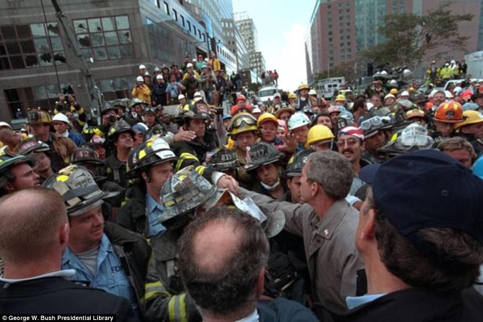 President George W. Bush is pictured above greeting firefighters, police and rescue personnel on September 14, 2001 in New York City