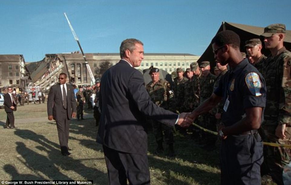 President George W. Bush greets rescue workers, firefighters and military personnel outside of the Pentagon