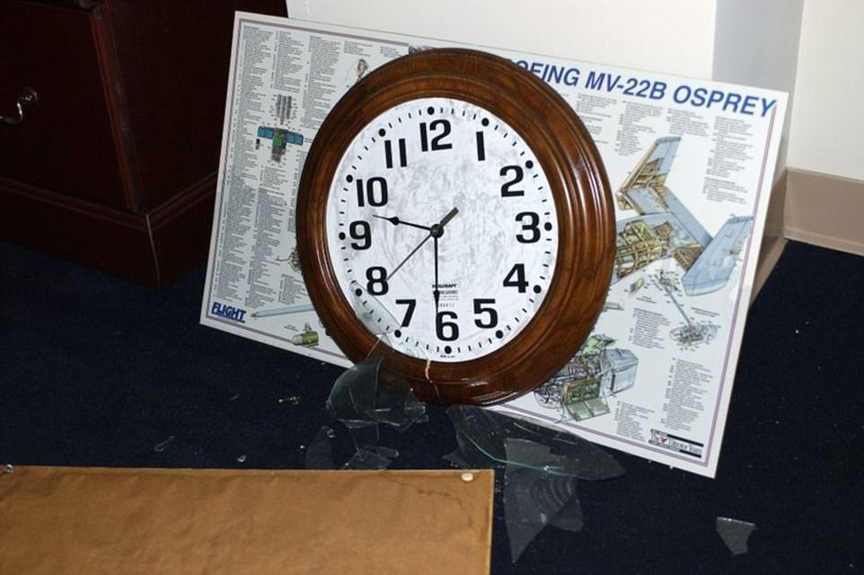 An image of a clock frozen at the time of impact at the Pentagon is pictured above. The image was taken by Sgt. Larry A. Simmons