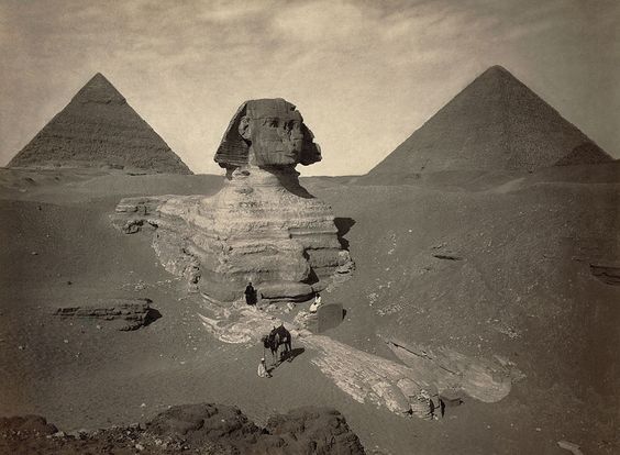 The Sphinx of Giza partially excavated with two pyramids in background Egypt 1867 1899